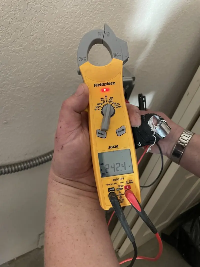 Voltage testing with clamp meter during Ceiling Fan Installation in Brownfields